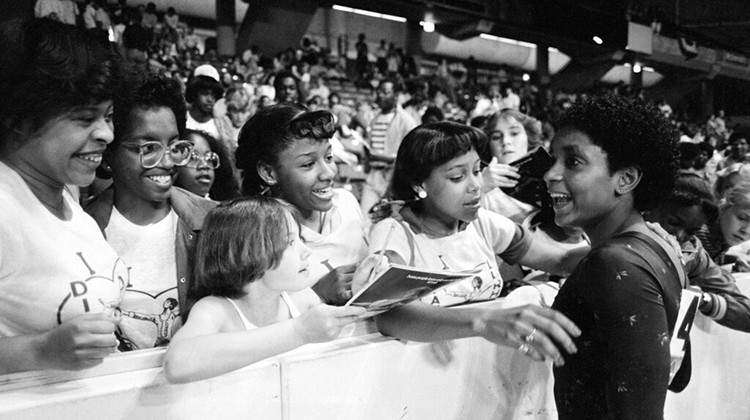 FILE - In this June 5, 1983, file photo, Dianne Durham, right, of Gary, Ind., gives autographs after winning the women's title at the McDonald's U.S.A. Gymnastic Championships at the University of Illinois in Chicago. Durham, the first Black woman to win a USA Gymnastics national championship, died on Thursday, Feb. 4, 2021, She was 52. - AP Photo/Lisa Genesen, File