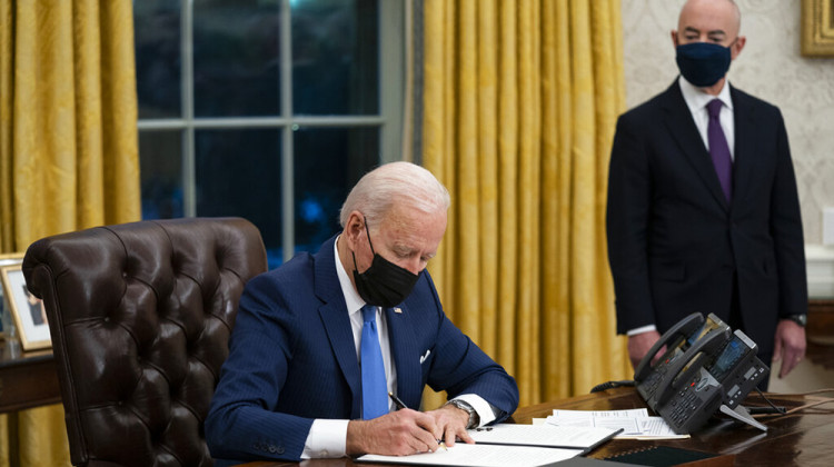 FILE - In this Tuesday, Feb. 2, 2021, file photo, Secretary of Homeland Security Alejandro Mayorkas looks on as President Joe Biden signs an executive order on immigration, in the Oval Office of the White House in Washington. - AP Photo/Evan Vucci, File