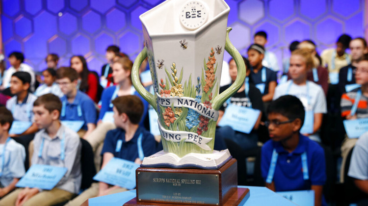 FILE - In this May 28, 2019 file photo, the Scripps National Spelling Bee trophy sits in front of competitors in Oxon Hill, Md. Cincinnati-based Scripps announced Monday, March 1, 2021, that J. Michael Durnil will take over immediately as bee director. He replaces Paige Kimble, who stepped down last year.  - AP Photo/Patrick Semansky, File
