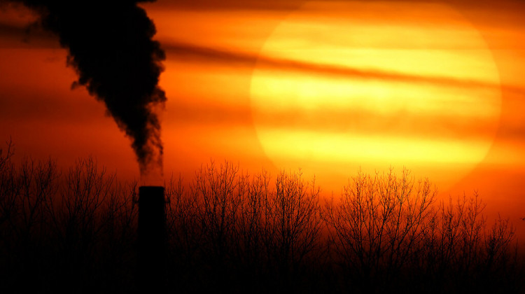 FILE - In this Feb. 1, 2021 file photo, emissions from a coal-fired power plant are silhouetted against the setting sun in Independence, Mo. - AP Photo/Charlie Riedel, File