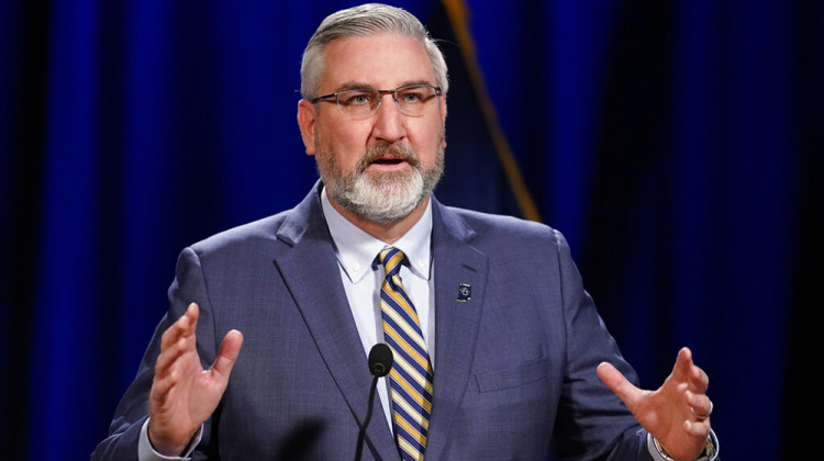 FILE - In this Jan. 19, 2021 file photo, Indiana Gov. Eric Holcomb delivers his State of the State address virtually, in Indianapolis.  Holcomb is attempting to block a new law giving state legislators more authority to intervene during public emergencies declared by the governor. - AP Photo/Darron Cummings File