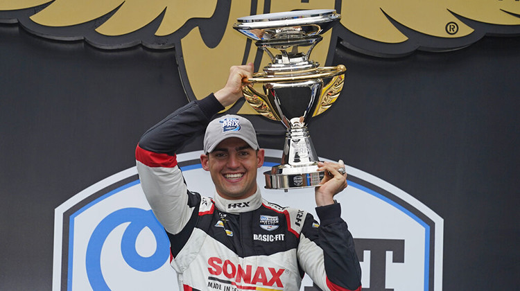 Rinus VeeKay, of the Netherlands, holds the trophy after winning the IndyCar auto race at Indianapolis Motor Speedway, Saturday, May 15, 2021, in Indianapolis.  - AP Photo/Darron Cummings