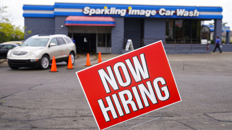 FILE - In this Sept. 2, 2020, file photo, a help wanted sign is displayed at a car wash in Indianapolis. Indiana’s Department of Workforce Development said Wednesday, July 7, 2021 that it still hasn’t decided how to continue payment of federal unemployment benefits more than a week after a judge ruled that the state must restart the extra $300 weekly payments to unemployed workers. - AP Photo/Michael Conroy, File