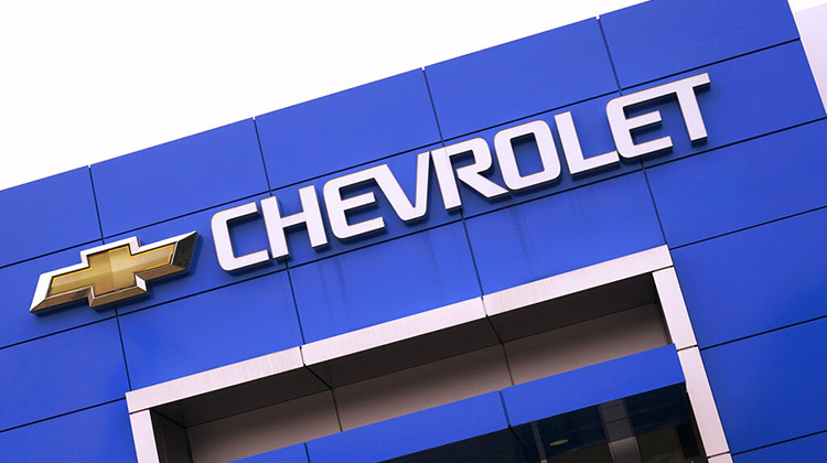 The Chevrolet logo is displayed on the facade of a dealership , Tuesday, Aug. 3, 2021, in Woburn, Mass. Despite a computer chip shortage that temporarily closed some of its factories, General Motors made a healthy $2.8 billion second-quarter net profit in the second quarter.  - AP Photo/Charles Krupa