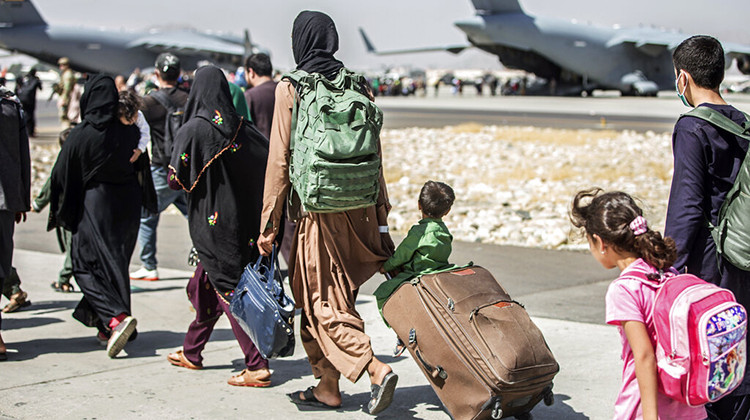 FILE - In this Aug. 24, 2021, file photo, provided by the U.S. Marine Corps, families walk towards their flight during ongoing evacuations at Hamid Karzai International Airport, in Kabul, Afghanistan.  - Sgt. Samuel Ruiz/U.S. Marine Corps via AP, File