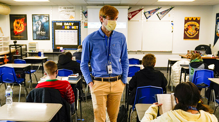 FILE - In this Dec. 10, 2020, file photo, Cooper Hanson, a substitute teacher at the Greenfield Intermediate School in Greenfield, Ind., is photographed in a classroom. Indiana schools reported more new COVID-19 cases during the last full week of August 2021 than at any previous time during the pandemic as the state continues to grapple with a surge in infections and hospitalizations. - AP Photo/Michael Conroy File