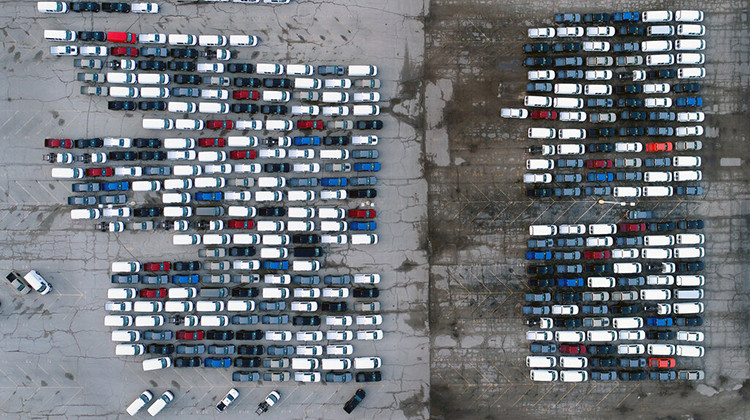 FILE - In this March 24, 2021 file photo, mid-sized pickup trucks and full-size vans are seen in a parking lot outside a General Motors assembly plant where they are produced in Wentzville, Mo. - AP Photo/Jeff Roberson, File