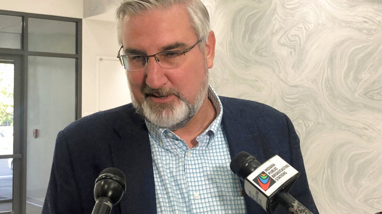 Indiana Gov. Eric Holcomb speaks with reporters during the Indiana Technology and Innovation Association conference in Fishers, Ind., on Friday, Oct. 8, 2021. Holcomb said he had not yet decided whether to appeal a court decision against his lawsuit challenging the expanded power state legislators gave themselves to intervene during public health emergencies.  - (AP Photo/Tom Davies)