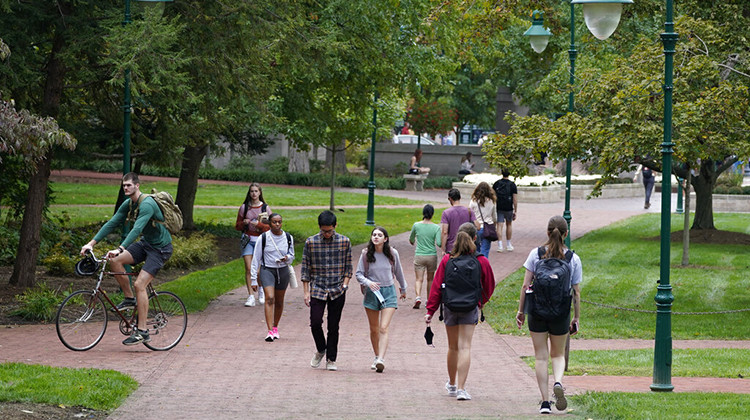 Students walk to and from classes on the Indiana University campus, Thursday, Oct. 14, 2021, in Bloomington, Ind. College communities such as Bloomington are exploring their options for contesting the results of the 2020 census, which they say do not accurately reflect how many people live there. - AP Photo/Darron Cummings