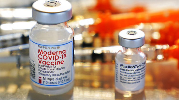 FILE - This Thursday, Feb. 25, 2021 file photo shows vials for the Moderna and Pfizer COVID-19 vaccines at a temporary clinic in Exeter, N.H. - AP Photo/Charles Krupa