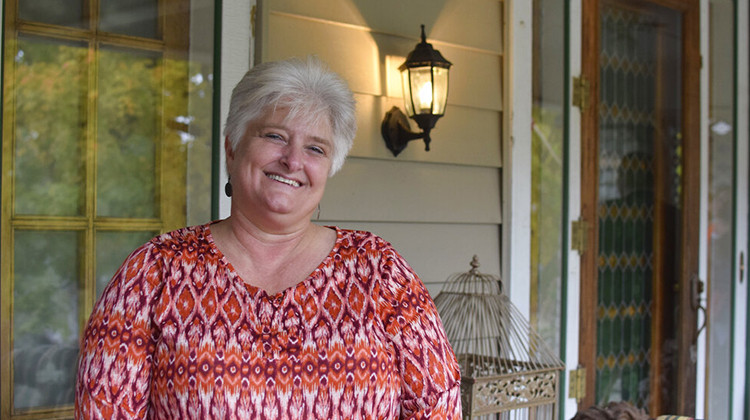 Tami Wenning poses outside a home in Greensburg, Ind., on Friday, Oct. 22, 2021. Wenning and her husband, Dan, will offer free babysitting and will fill in on Grandparents Day at school as part of a new incentive program to attract remote workers to the southeastern Indiana city.  - Casey Smith/Report for America via AP