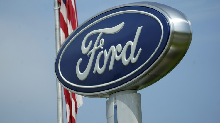 A Ford logo is seen on signage at Country Ford in Graham, N.C., Tuesday, July 27, 2021. Ford and Purdue University are working to create a new charging station cable that could combine with in-development vehicle charging technology, making it easier for people to transition to electric vehicles with seamless re-charging.  - (AP Photo/Gerry Broome)