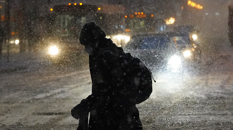 A lone pedestrian navigates Chicago's famed Loop in windy, falling snow and slushy street conditions Wednesday, Feb. 2, 2022. The same winter storm will bring a mix of rain, freezing rain and snow to Indiana. - AP Photo/Charles Rex Arbogast