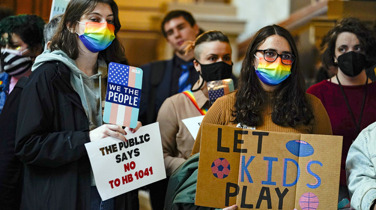 People gather to protest against HB1041, a bill to ban transgender women and girls from participating in school sports that match their gender identity, during a rally at the Statehouse in Indianapolis, Wednesday, Feb. 9, 2022. The Republican-backed bill drew nearly three hours of testimony on Wednesday, as lawmakers considered whether to further advance the bill. - AP Photo/Michael Conroy