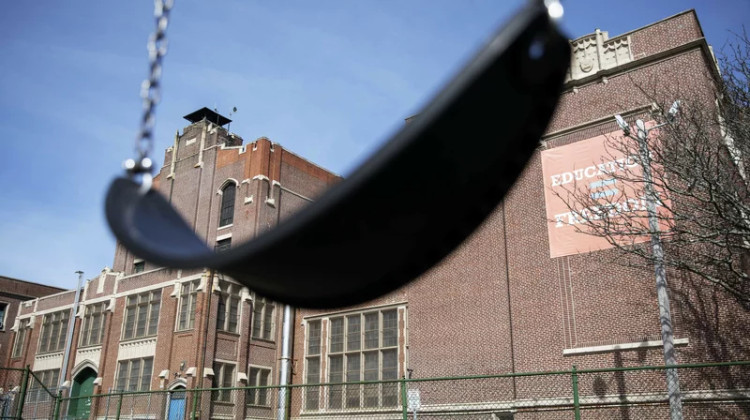 A swing sits empty on a playground outside in Providence, R.I. Experts say the end of the expanded child tax credit was a key factor in the big rise in child poverty. - 
David Goldman/AP