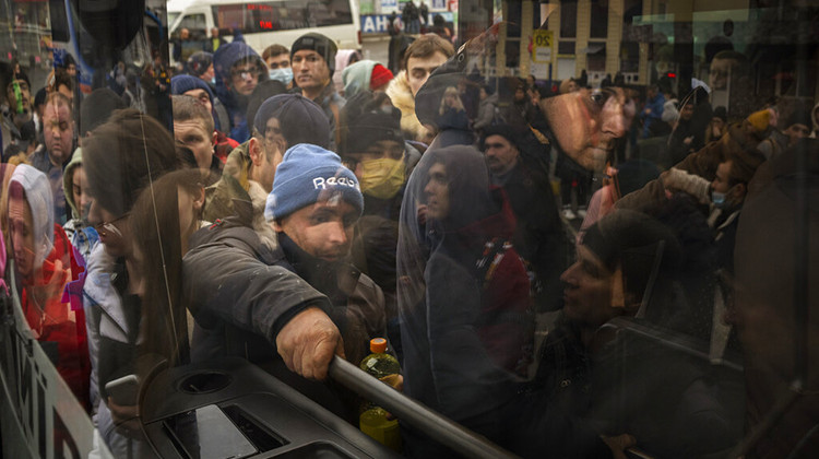 People try to get on a bus as they leave Kyiv, Ukraine, Thursday, Feb. 24, 2022. Russia launched a wide-ranging attack on Ukraine on Thursday, hitting cities and bases with airstrikes or shelling, as civilians piled into trains and cars to flee. - AP Photo/Emilio Morenatti