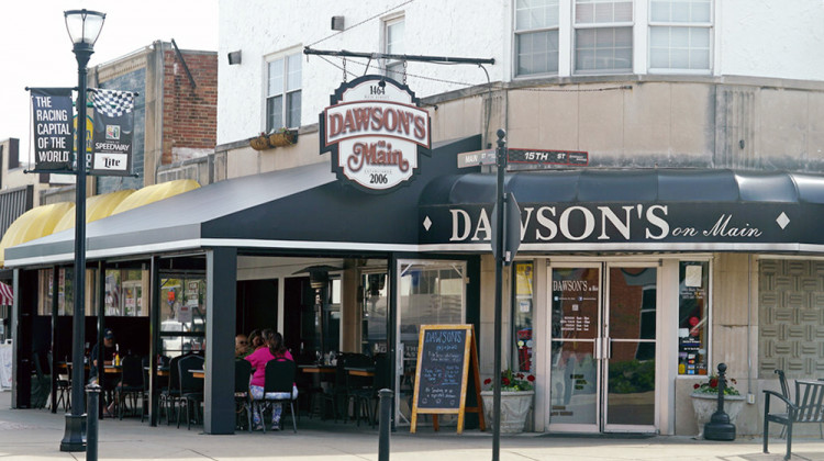 Guests visit Dawson's on Main in downtown Speedway, Ind., Wednesday, May 25, 2022, Customers are flooding into the popular local restaurant night after night and not a penny is pinched. - AP Photo/Darron Cummings