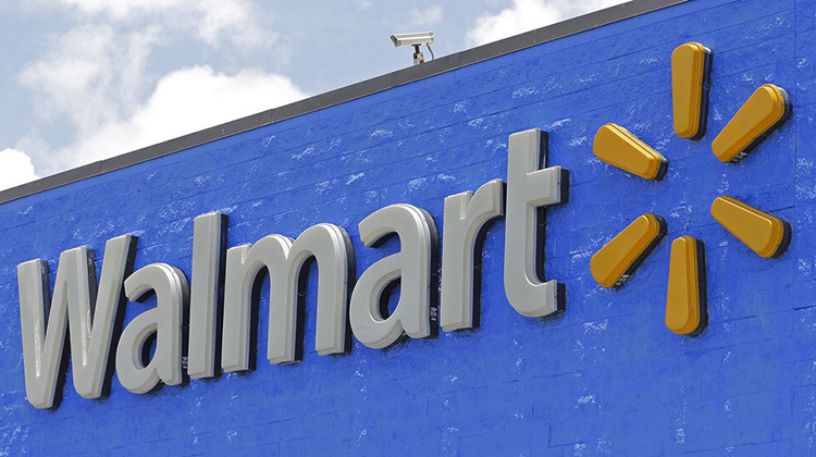 FILE - A Walmart sign displayed on the facade of a store in Hialeah Gardens, Fla., on June 1, 2017. Walmart is adding four new fulfillment centers to its existing capacity, a move that will bring more than 4,000 jobs and make next- or two-day shipping available to more Americans. - AP Photo/Alan Diaz, File