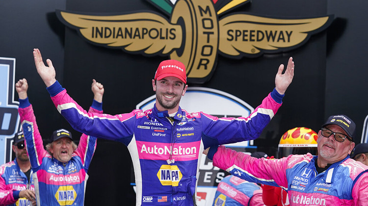 Alexander Rossi, center, celebrates after winning an IndyCar auto race at Indianapolis Motor Speedway, Saturday, July 30, 2022, in Indianapolis. - AP Photo/Darron Cummings