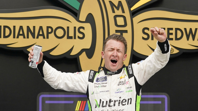 AJ Allmendinger celebrates after winning a NASCAR Xfinity Series auto race at Indianapolis Motor Speedway, Saturday, July 30, 2022, in Indianapolis. - AP Photo/Darron Cummings