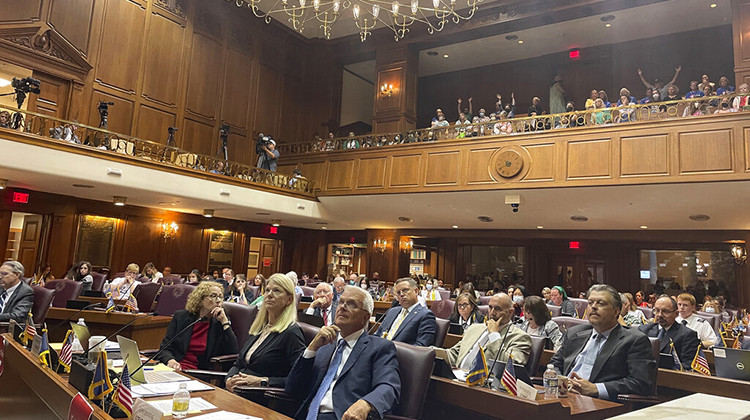 Indiana House committee members listen to testimony on its version of a Senate-approved abortion ban as listeners in an upstairs gallery of the Indiana House chamber in Indianapolis, Tuesday, Aug. 2, 2022, indicate their support.  - AP Photo/Arleigh Rodgers