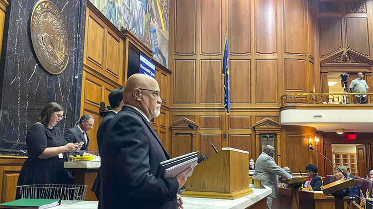 Republican Rep. Tim Brown, center, listens to Democratic Rep. Gregory Porter, right, speak at the Statehouse in Indianapolis, Friday, Aug. 5, 2022, on a bill that would issue $200 rebate payments to taxpayers and allocate $45 million more in the coming year toward state agencies that support families, young children and people who adopt. The House passed the relief bill Aug. 5, 2022 with support from both caucuses. - AP Photo/Arleigh Rodgers