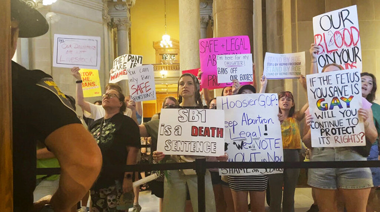 Abortion-rights protesters fill Indiana Statehouse corridors and cheer outside legislative chambers, Friday, Aug. 5, 2022, as lawmakers vote to concur on a near-total abortion ban, in Indianapolis. - AP Photo/Arleigh Rodgers