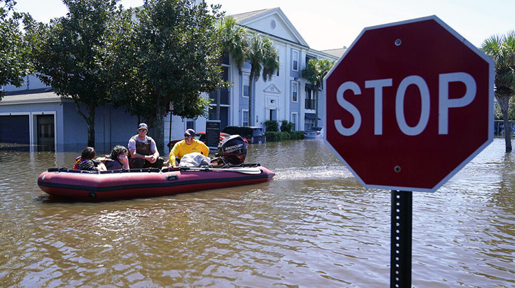 University of Central Florida students are evacuated after their apartment complex near the campus was totally flooded by rain from Hurricane Ian, Friday, Sept. 30, 2022, in Orlando, Fla. - AP Photo/John Raoux
