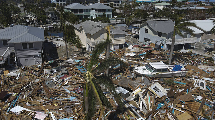 In this photo taken with a drone, debris from destroyed buildings swept from the beachfront lies amid damaged homes, two days after the passage of Hurricane Ian, in Fort Myers Beach, Fla., Friday, Sept. 30, 2022.  - AP Photo/Rebecca Blackwell