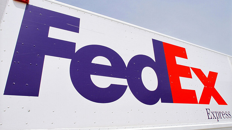 FILE - The FedEx logo is seen on a delivery truck, Tuesday, June 21, 2011, in Springfield, Ill. On Monday, Oct. 17, 2022, a federal judge dismissed FedEx from a lawsuit filed by relatives of five of the eight people who were fatally shot last year at an Indianapolis warehouse by a former employee of the shipping giant. - AP Photo/Seth Perlman, File