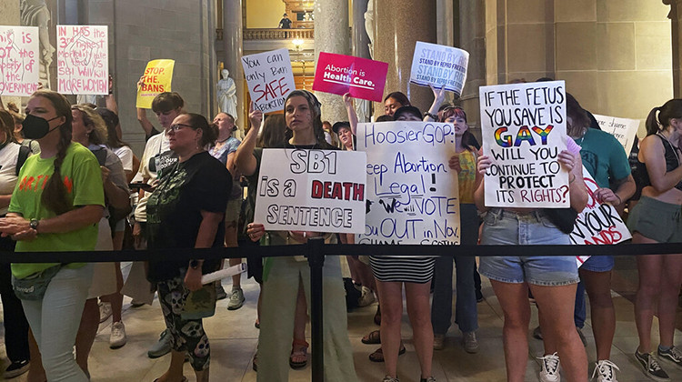 FILE - Abortion-rights protesters fill Indiana Statehouse corridors and cheer outside legislative chambers, Friday, Aug. 5, 2022, as lawmakers vote to concur on a near-total abortion ban, in Indianapolis. Critics of religious freedom laws often argue they are used to discriminate against LGBTQ people and only protect a conservative Christian worldview. But following the U.S. Supreme Court’s overturning of Roe v. Wade in June, religious abortion-rights supporters are using these laws to pro - AP Photo/Arleigh Rodgers, File