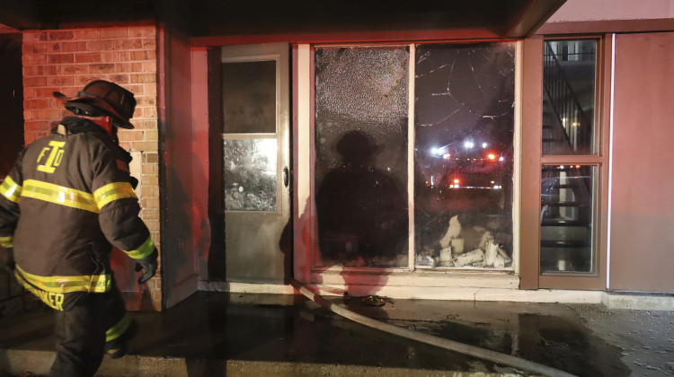 This photo provided by the Indianapolis Fire Department shows an Indianapolis firefighter outside of an apartment where a Jan. 9 fire left a man and four children hospitalized. The 31-year-old man and his 15-month daughter died within days of the blaze. The Indianapolis Fire Department said Thursday, Jan. 26, 2023 the man’s 3-year-old daughter died at a hospital. A 12-year-old boy remains hospitalized, while a 14-year-old boy has been released from the hospital and is continuing to recover - Indianapolis Fire Department via AP