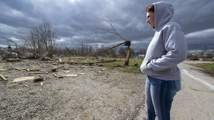 Jaycee Ahlefeld surveys the damage left after a late-night tornado devastated the area in Sullivan, Ind., Saturday, April 1, 2023. Ahlefeld's son attended a day care that had been on what is now an empty lot. Multiple deaths were reported in the area following the storm.  - AP Photo/Doug McSchooler
