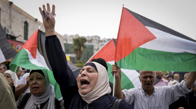 Palestinians attend a rally in support of Hamas and the Gaza Strip in the West Bank city of Nablus on Monday. - Majdi Mohammed / AP