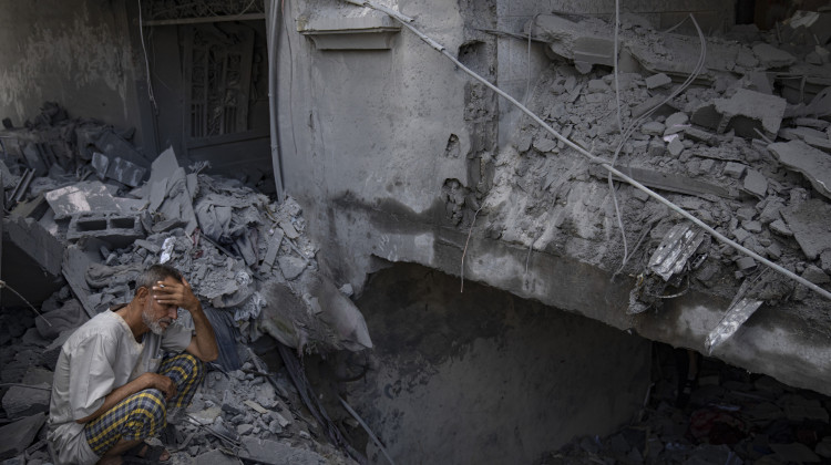 A man sits outside his building which was destroyed during Israeli bombardment in Rafah refugee camp in Gaza Strip on Tuesday, Oct. 17, 2023. - (AP Photo/Fatima Shbair)