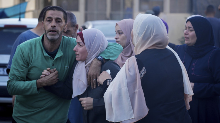 Palestinians mourn relatives killed in the Israeli bombardment of the Gaza Strip in front of the morgue in Deir al Balah on Monday. - Hatem Moussa / AP