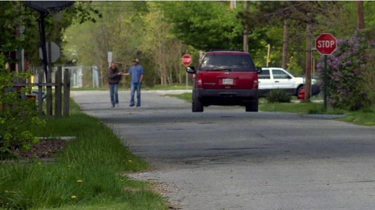 Residents walk the streets of Austin, Ind., the town where the HIV outbreak began. - Barbara Brosher