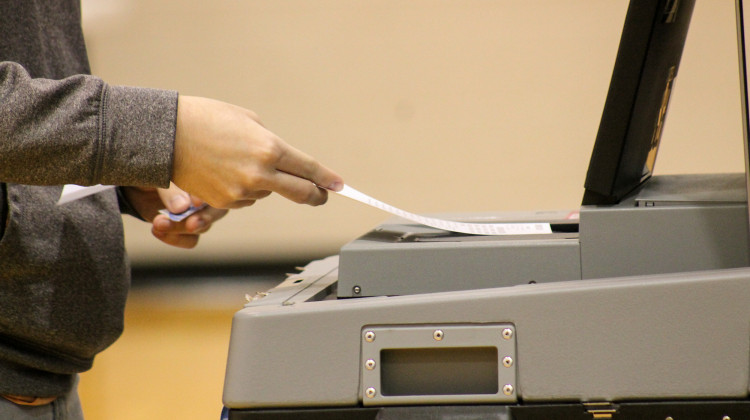 A voter submits their ballot at a vote center in Indianapolis. Voters approved seven school referendums Tuesday. - Lauren Chapman