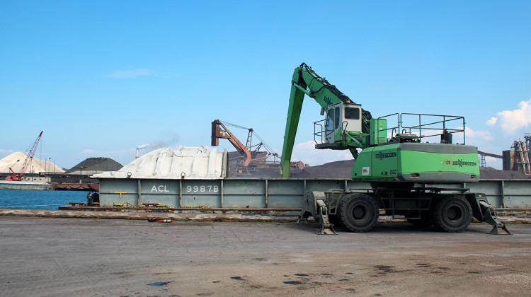 A loader scoops magnesite, a mineral commonly used in manufacturing, out of a barge in Burns Harbor. The barge responsible for the spill was carrying diesel fuel. - FILE PHOTO: Annie Ropeik/IPB News