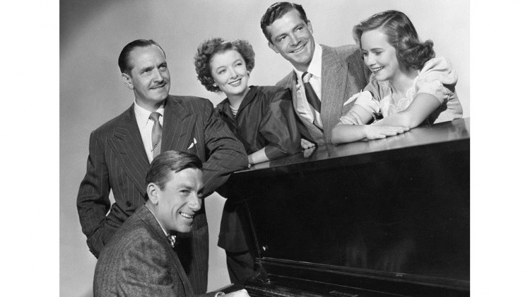The Best Years of Our Lives, 1946 (publicity still) Standing, L-R: Frederick March, Myrna Loy, Dana Andrews, Teresa Wright; seated at piano: Hoagy Carmichael.