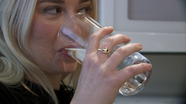 IU Public Health student Samantha Bettinger takes a sip of her tap water in the late summer when algae issues on Lake Monroe were causing taste and odor issues with the city of Bloomington's water. - Devan Ridgeway/WTIU