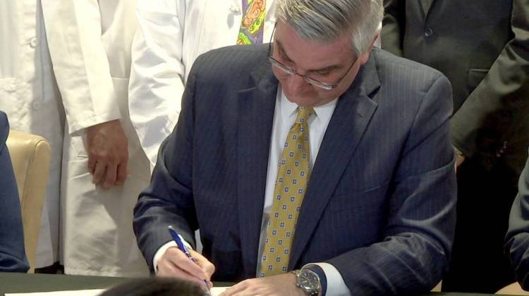 Gov. Eric Holcomb signs Senate Enrolled Act 360 at the Peyton Manning Children's Hospital. - Lauren Chapman/IPB News