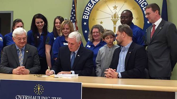 Indiana Gov. Mike Pence signs legislation to simplify the Bureau of Motor Vehicle fee structure. - Brandon Smith