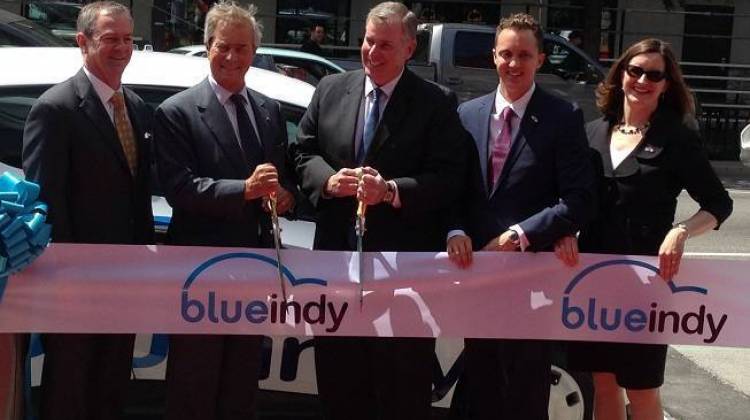 Indianapolis Mayor Greg Ballard, center, at the unveiling of BlueIndy in May 2014. - WFYI News