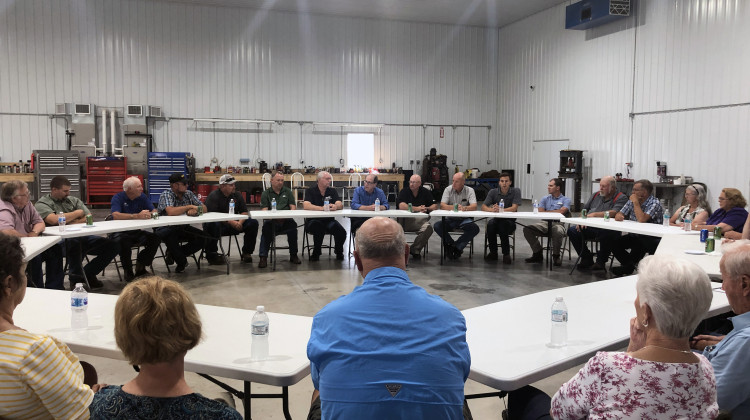 A group of farmers speak with US Senator Mike Bryan (R-IN) at a meeting outside of Evansville. - Brock Turner/WTIU-WFIU
