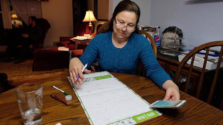 Brenda Davis carefully schedules all of the 3 teenage boys' appointments on a calendar. - Michelle Faust