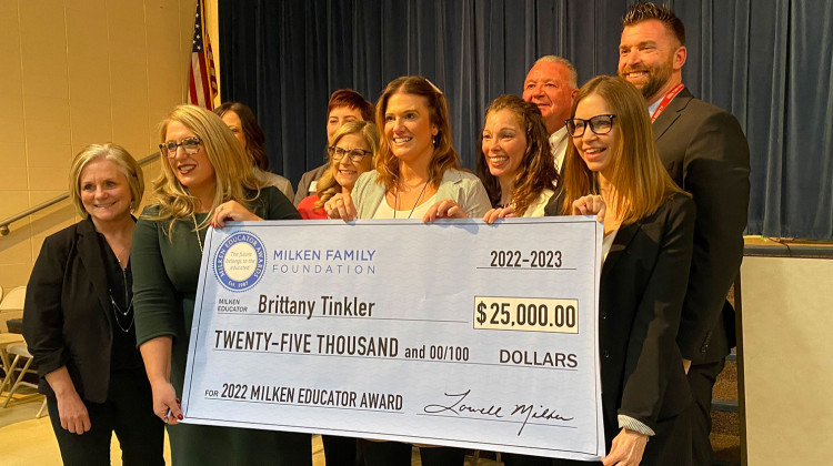 Brittany Tinkler, center, of Rosa Parks Elementary in the Metropolitan School District of Perry Township stands in the school’s cafeteria as she receives the Milken Educator Award on Wednesday, Feb. 8. 2023. - Elizabeth Gabriel / WFYI