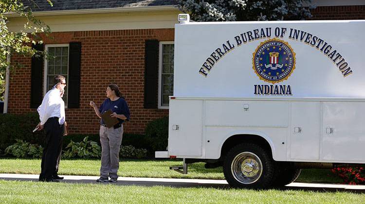 Federal agents talk outside the home of the American Senior Communities CEO James Burkhart in Carmel, Ind., Tuesday, Sept. 15, 2015. FBI and IRS agents spent several hours searching the home. Agents also went to the companyâ€™s Indianapolis headquarters. -  AP Photo/Michael Conroy