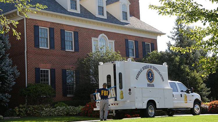A federal agent carries equipment into the home of the American Senior Communities CEO James Burkhart in Carmel, Ind., Tuesday, Sept. 15, 2015. FBI and IRS agents spent several hours searching the home. Agents also went to the companyâ€™s Indianapolis headquarters.  - AP Photo/Michael Conroy
