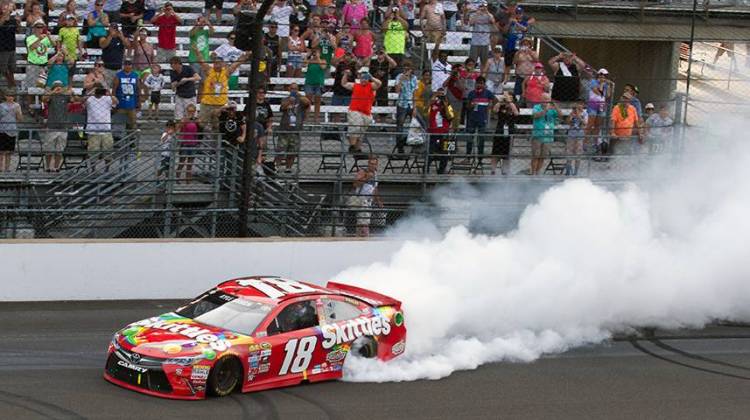Kyle Busch celebrates his second consecutive Brickyard 400 victory with a burnout on the front stretch of the Indianapolis Motor Speedway. - Doug Jaggers